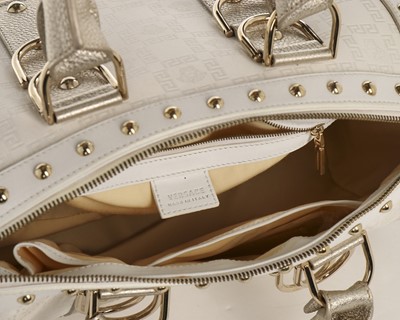 Lot 11 - A Versace 'Snap Out Of It' white and metallic...