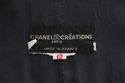 Lot 32 - A Chanel navy bouclé mid-length coat, 1990s,...