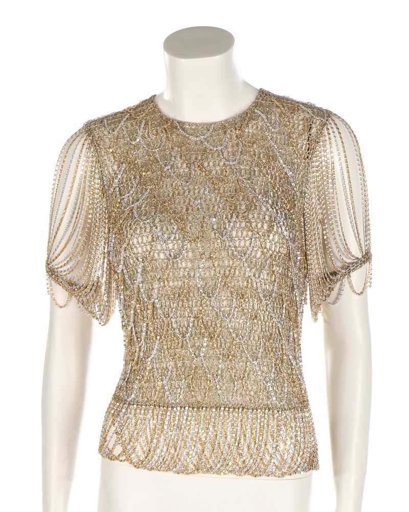 Lot 34 - A Loris Azzaro gold crochet and chain fringed...