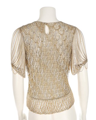 Lot 34 - A Loris Azzaro gold crochet and chain fringed...