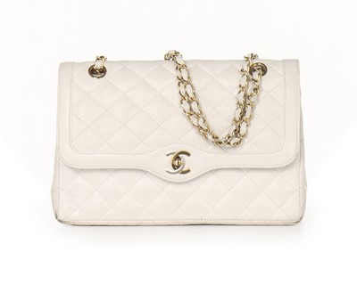 Lot 13 - A Chanel white quilted leather handbag, 1980s,...