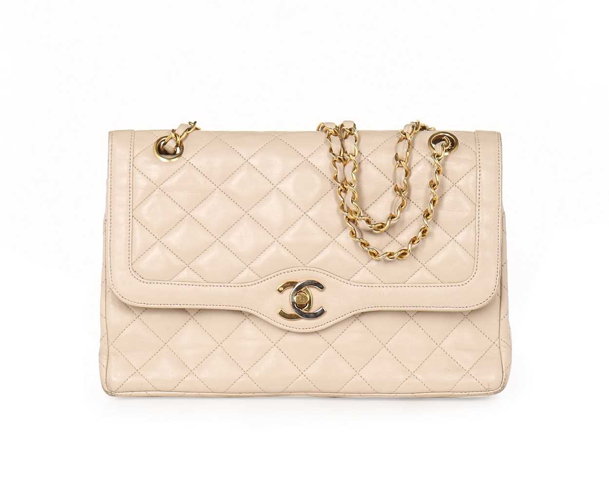 Lot 14 - A Chanel quilted beige leather handbag, 1980s,...