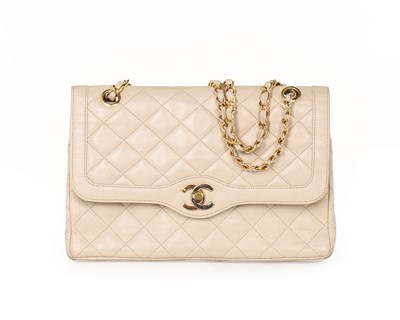 Lot 14 - A Chanel quilted beige leather handbag, 1980s,...