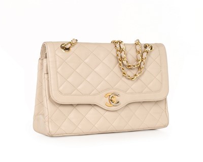 Lot 14 - A Chanel quilted beige leather handbag, 1980s,...