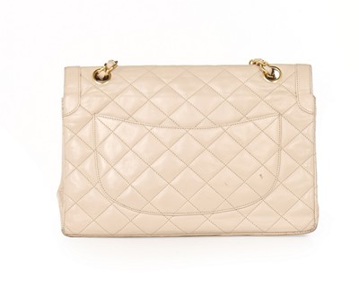 Lot 14 - A Chanel quilted beige leather handbag, 1980s,...