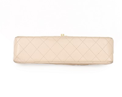 Lot 14 - A Chanel quilted beige leather handbag, 1980s,...