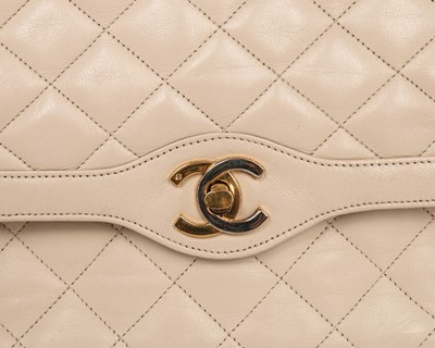 Lot 14 - A Chanel quilted beige leather handbag, 1980s,...