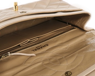 Lot 14 - A Chanel quilted beige leather handbag, 1980s,...