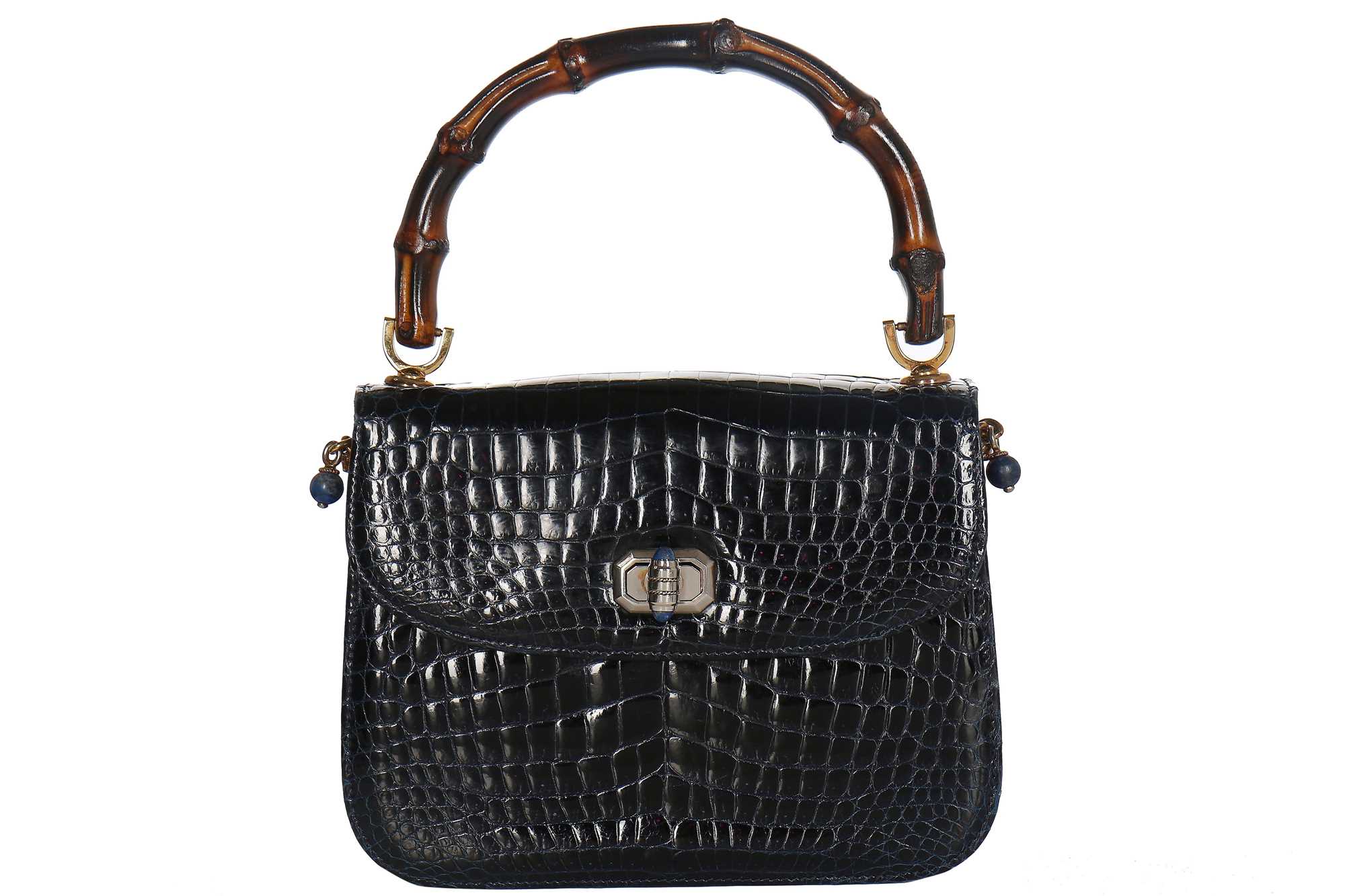 Lot 8 - A fine and rare Gucci ink-blue crocodile handbag with bamboo handle, 1960s