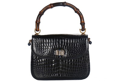 Lot 8 - A fine and rare Gucci ink-blue crocodile handbag with bamboo handle, 1960s