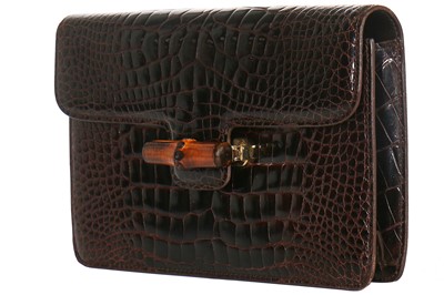 Lot 10 - A Gucci brown crocodile clutch bag with bamboo lift-clasp, early 1970s