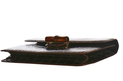 Lot 10 - A Gucci brown crocodile clutch bag with bamboo lift-clasp, early 1970s