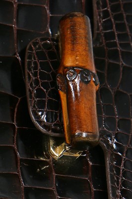 Lot 10 - A Gucci brown crocodile clutch bag with bamboo lift-clasp, early 1970s
