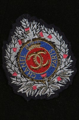 Lot 19 - A Chanel by Karl Lagerfeld black wool blazer covered with embroidered badges, A/W 1988-89