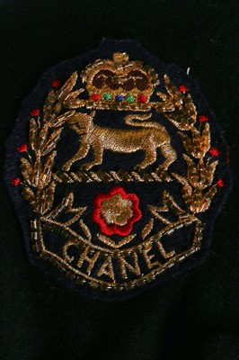 Lot 19 - A Chanel by Karl Lagerfeld black wool blazer covered with embroidered badges, A/W 1988-89