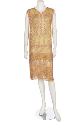 Lot 5 - A beaded mustard muslin flapper dress, mid-1920s