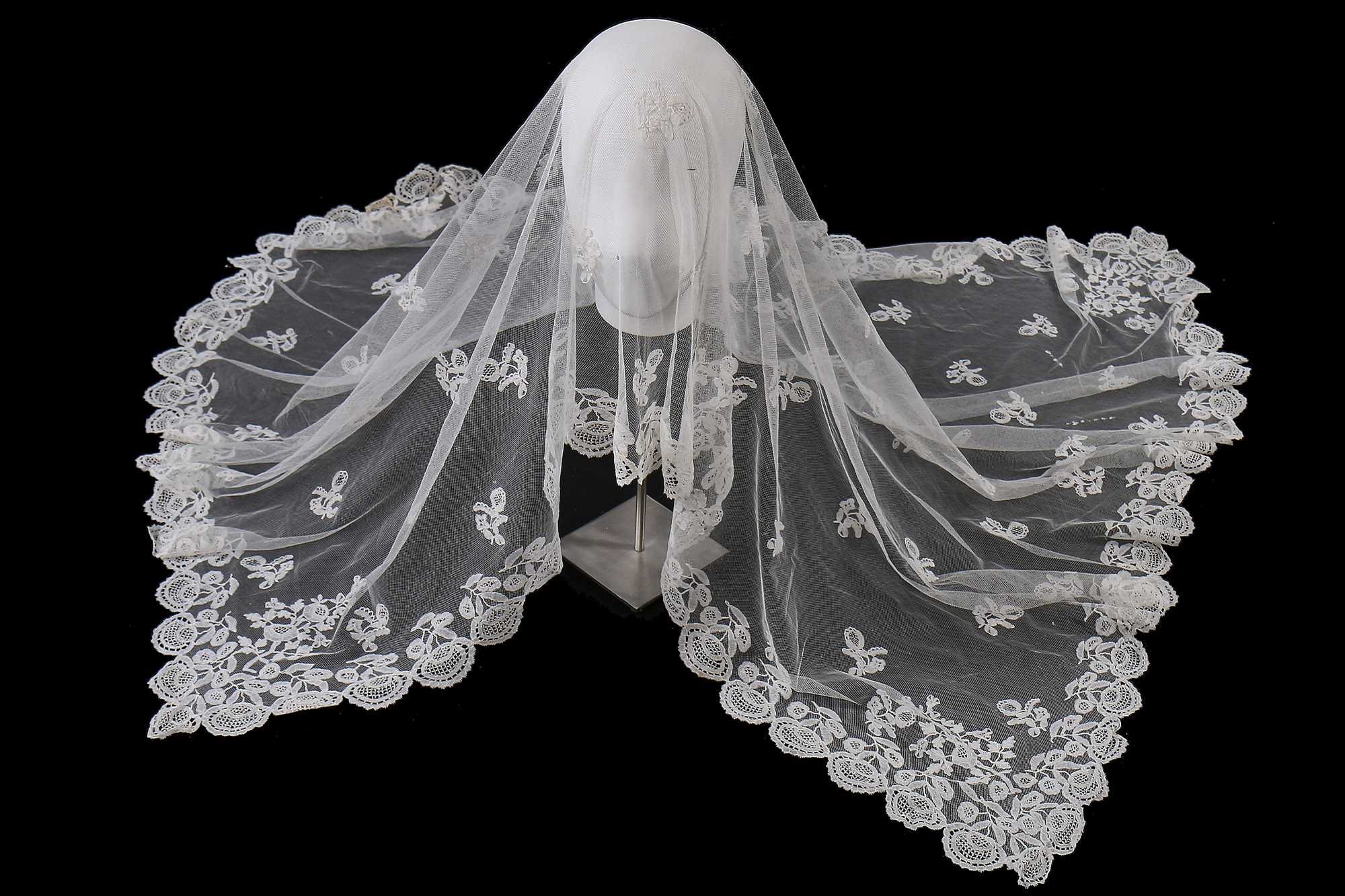 Lot 384 - A Honiton appliqué lace veil, 1830s and later remounted