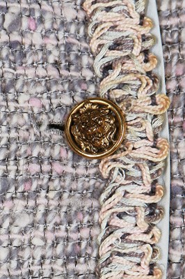 Lot 17 - A Chanel couture grey-pink tweed suit, 1960
