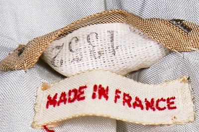 Lot 17 - A Chanel couture grey-pink tweed suit, 1960