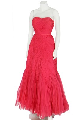 Lot 94 - A raspberry-pink pleated chiffon evening gown in the style of Jean Dessès, circa 1959