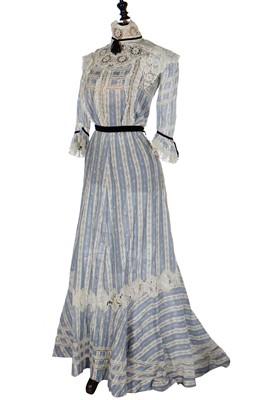 Lot 19 - A floral printed blue and white striped cotton gown, circa 1905