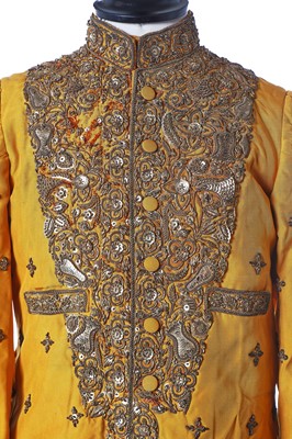 Lot 273 - A young man's brilliant yellow silk court coat, Indian, 1910-20