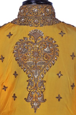 Lot 258 - A young men's brilliant yellow silk court coat, Indian, 1910-20