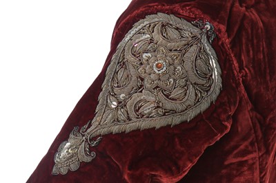 Lot 257 - A boys' embroidered scarlet velvet court coat, Indian, late 19th century