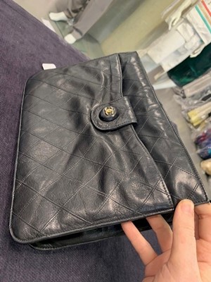 Lot 13 - A Chanel quilted black lambskin leather pochette, 1986-88
