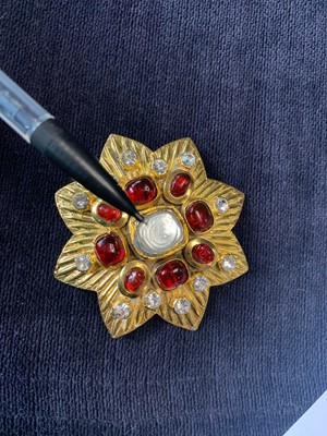 Lot 20 - A Chanel gilt eight-pointed flower-head-shaped brooch, 1985