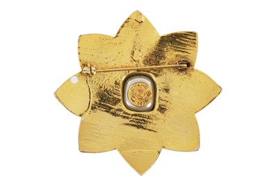 Lot 20 - A Chanel gilt eight-pointed flower-head-shaped brooch, 1985
