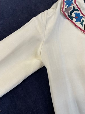 Lot 65 - An ivory silk summer coat made from a Central Asian embroidered suzani, circa 1928