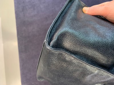 Lot 15 - A Chanel navy leather bucket bag with leather shoulder strap, 1994-1997