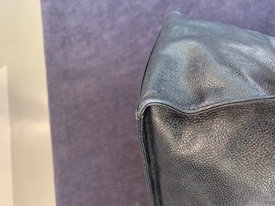 Lot 15 - A Chanel navy leather bucket bag with leather shoulder strap, 1994-1997