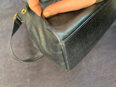 Lot 15 - A Chanel navy leather bucket bag with leather shoulder strap, 1994-1997