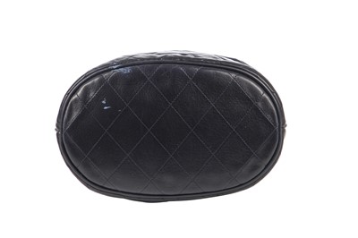 Lot 14 - A Chanel waxed canvas and navy quilted leather bucket bag, 1986-1988