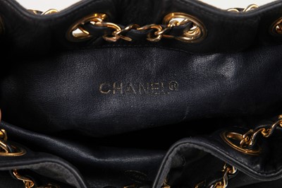 Lot 14 - A Chanel waxed canvas and navy quilted leather bucket bag, 1986-1988