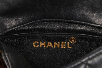 Lot 3 - A Chanel mini quilted navy lambskin leather flap bag, 1980s-early 1990s