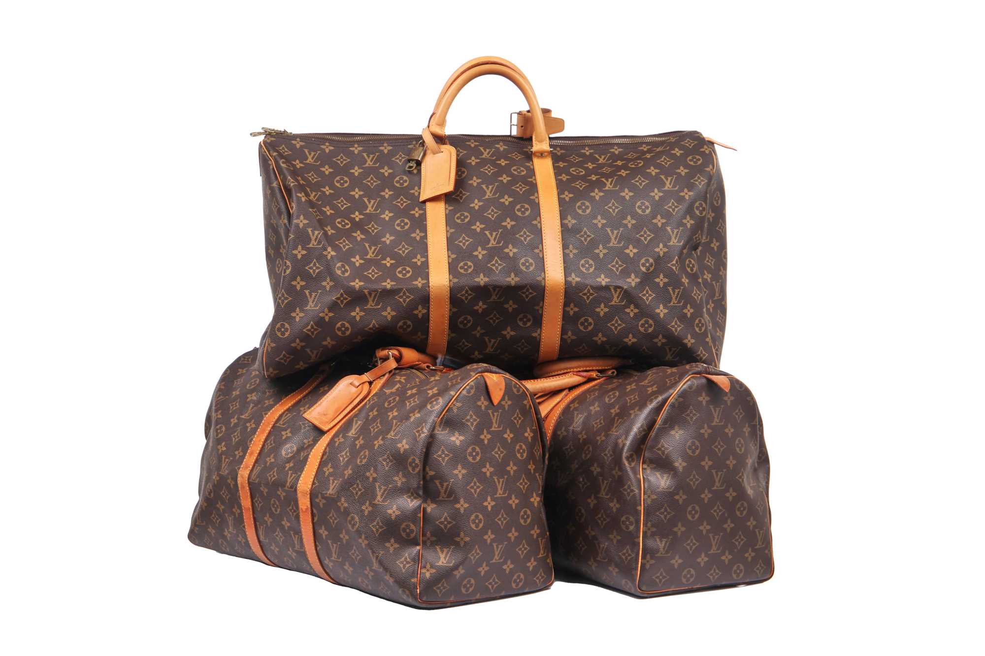 Lot 58 - Three Louis Vuitton monogrammed canvas leather holdalls