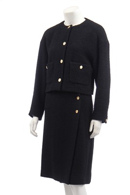 Lot 18 - A Chanel black bouclé wool suit, 1980s