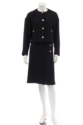 Lot 18 - A Chanel black bouclé wool suit, 1980s