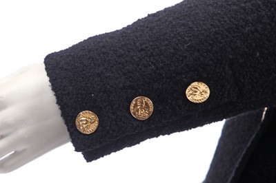 Lot 18 - A Chanel black bouclé wool suit, 1980s