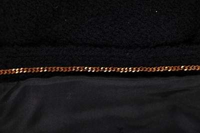 Lot 18 - A Chanel black bouclé wool suit, 1980s