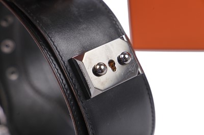Lot 56 - An Hermès black leather belt with metal 'lock' clasp, modern