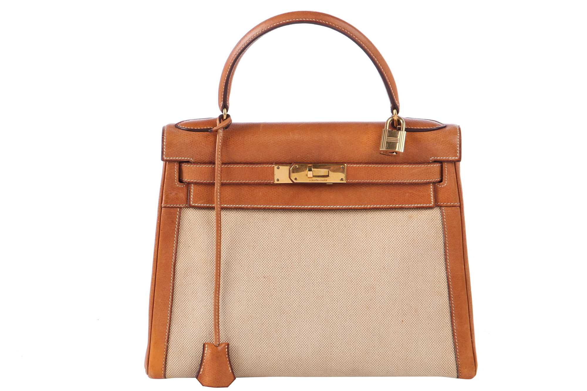 Lot 47 - An Hermès canvas and natural leather Retourné Kelly 28, 1979