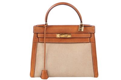 Lot 47 - An Hermès canvas and natural leather Retourné Kelly 28, 1979