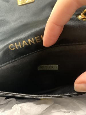 Lot 9 - A Chanel quilted black satin evening bag, 1994-96