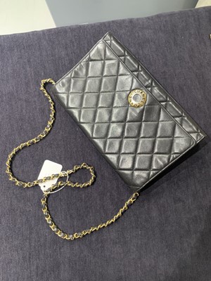 Lot 7 - A Chanel quilted black leather flap bag, 1980s