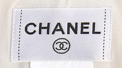 Lot 11 - A Chanel cream and black wool dress, 2005,...
