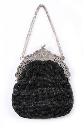 Lot 334 - A beaded purse with ornate continental silver...
